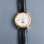 Vacheron Constantin watch front, white dial, gold case, black leather strap