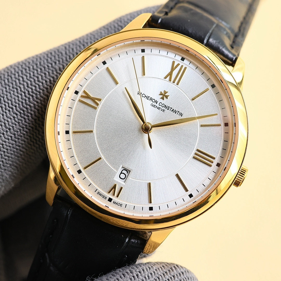 Gold-tone wristwatch with white dial, Roman numerals, star-shaped center detail, black leather strap.
