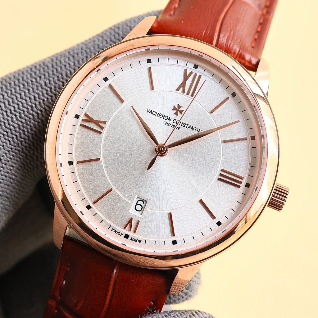 Rose gold-tone wristwatch with white dial, Roman numerals, red leather strap, gold crown.