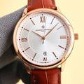 Rose gold-tone wristwatch with white dial, Roman numerals, red leather strap, gold crown.