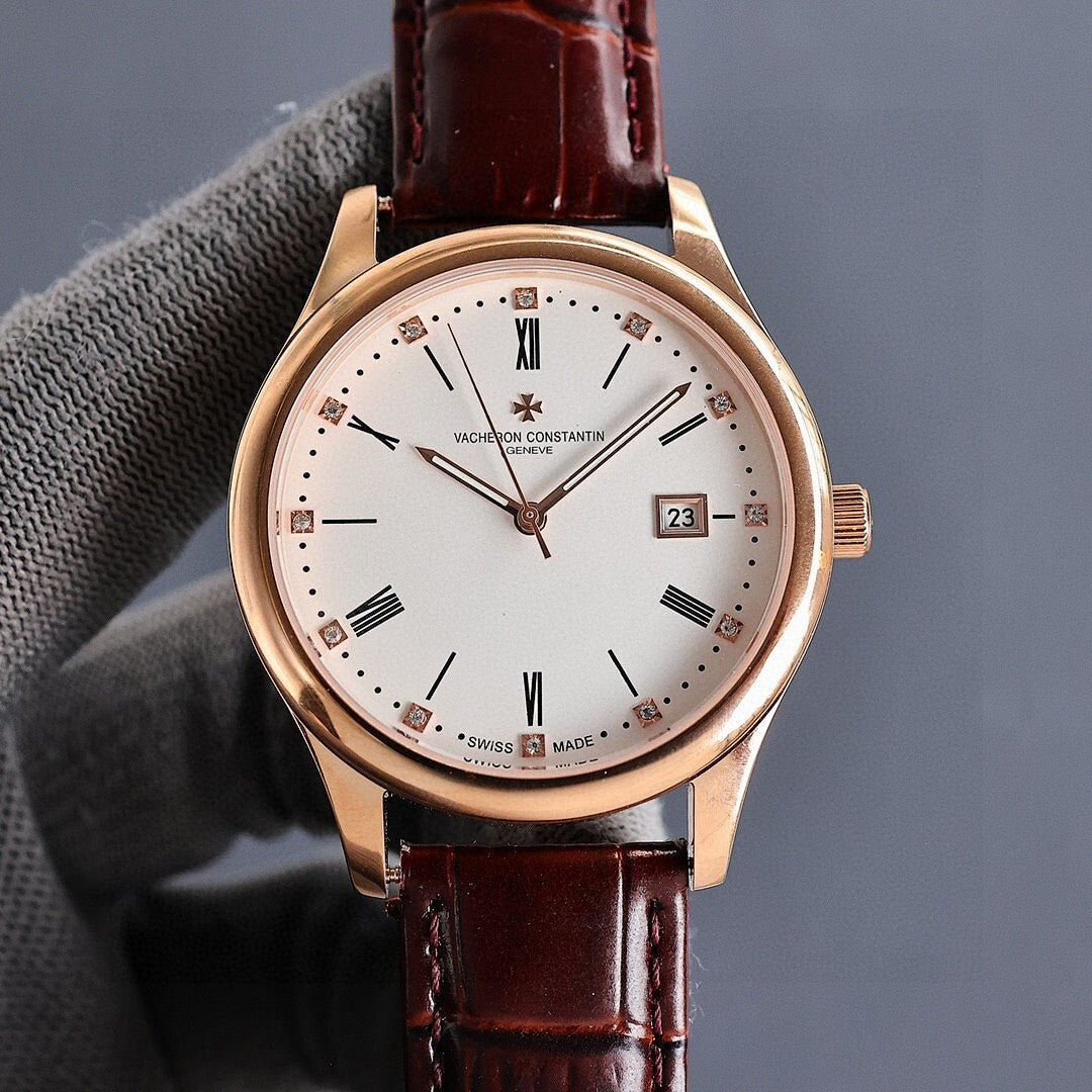 Gold wristwatch with white dial, dark brown leather strap, and date window showing 23