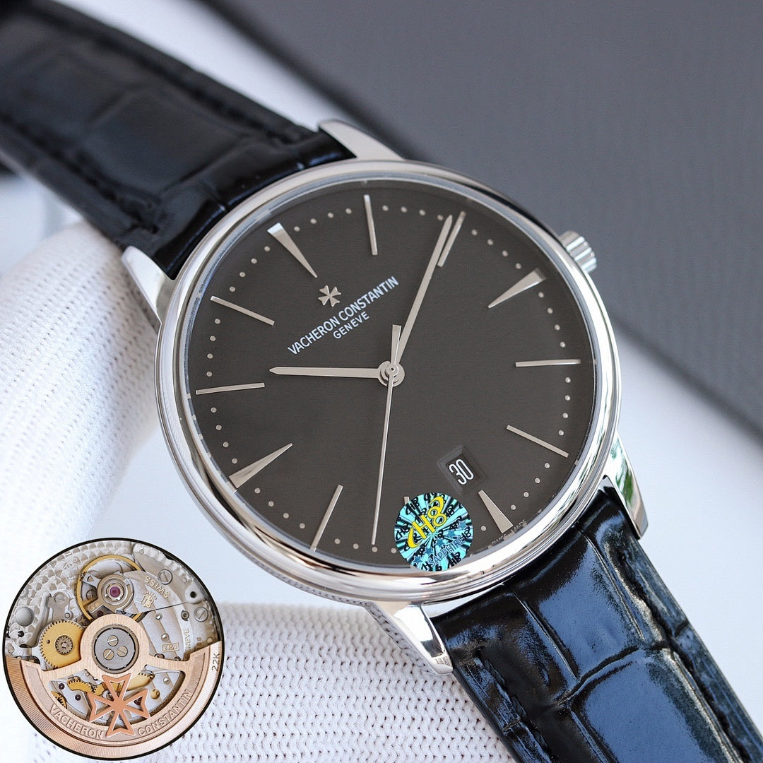 Wristwatch with dark dial, black leather strap, steel case, and date window