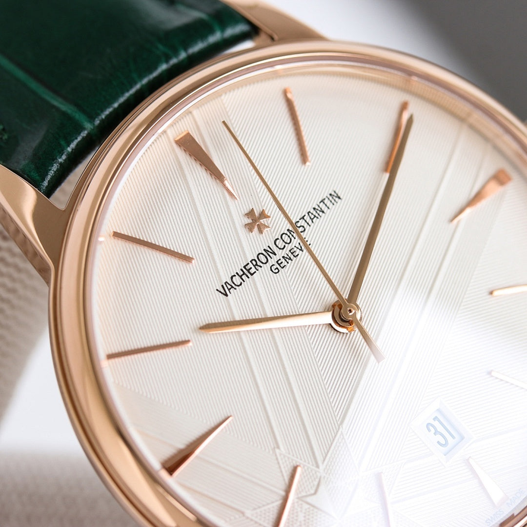 Close-up rose-gold wristwatch with white dial, green leather strap, baton hands and markers