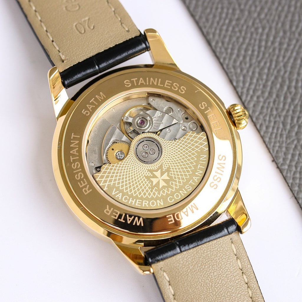 Stainless steel watch case back with exposed movement and black leather strap