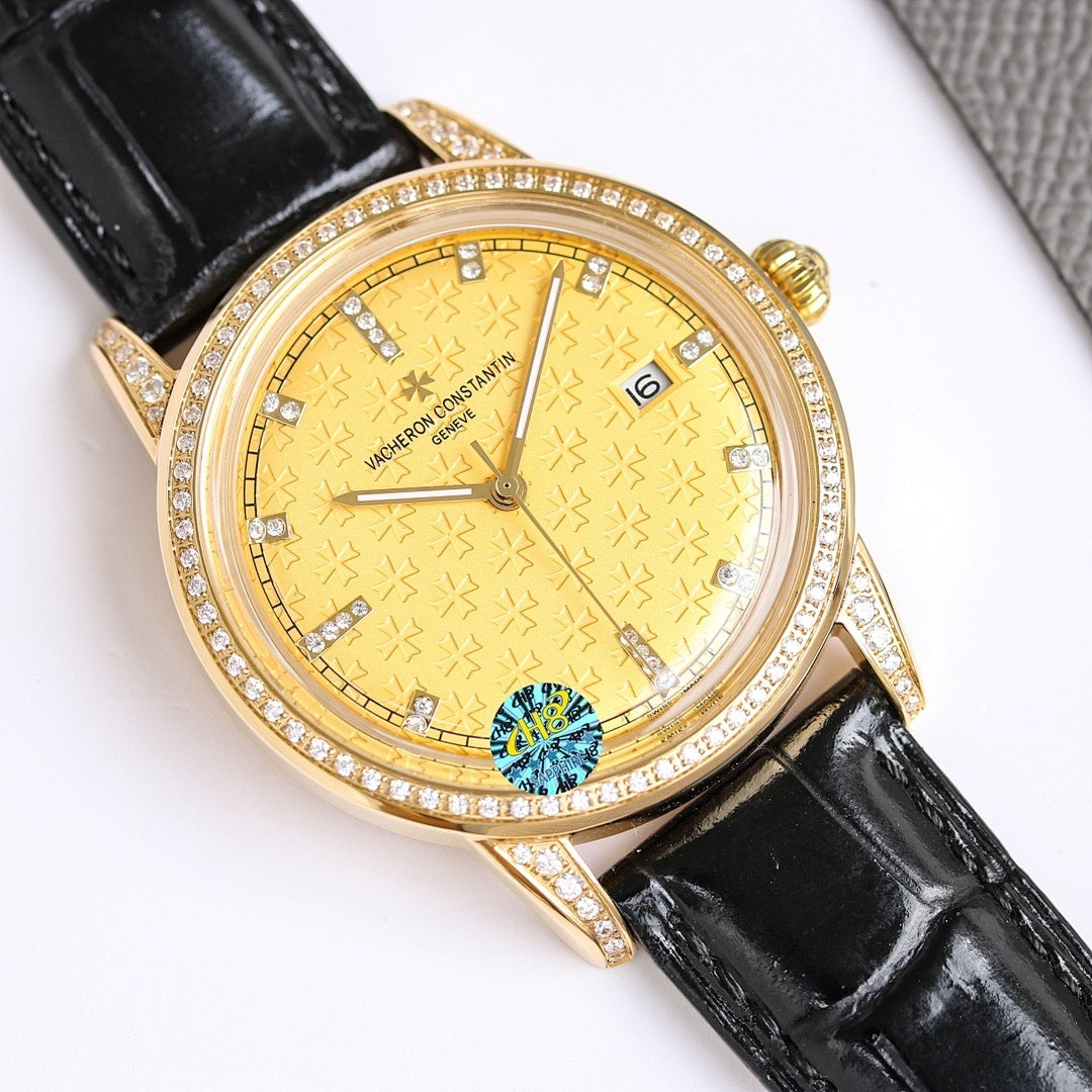 Gold-tone diamond bezel wristwatch with black leather strap, gold textured dial and date at 3