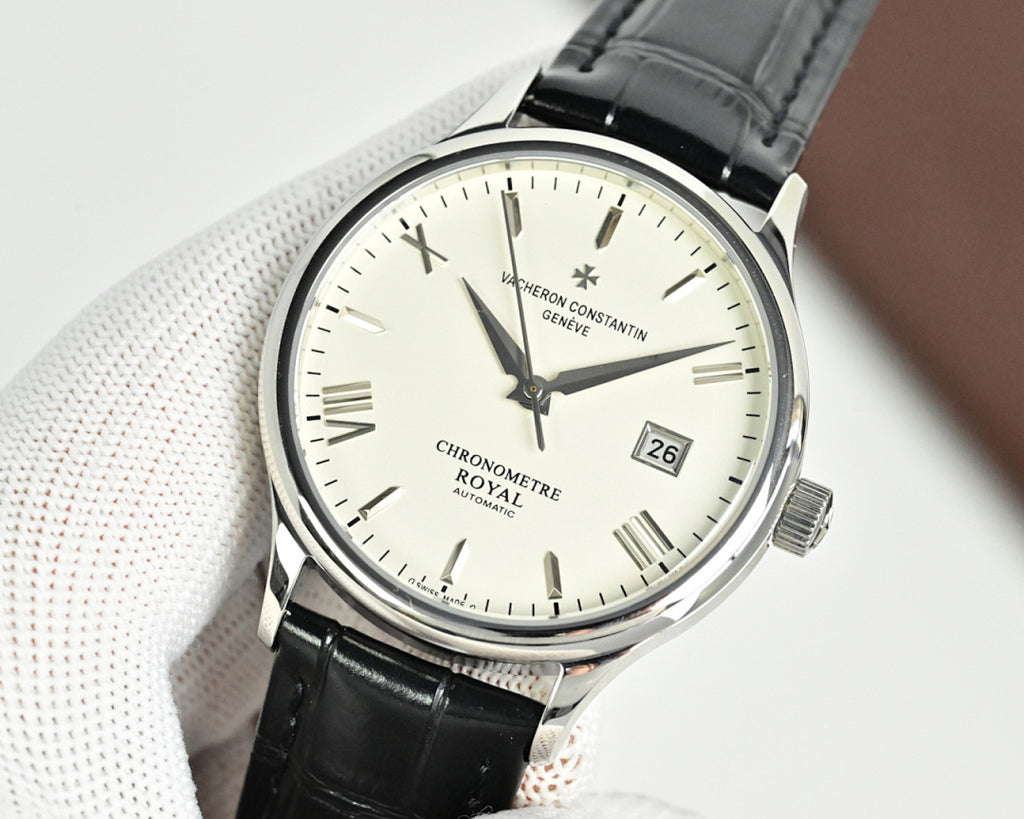 Analog wristwatch with black leather strap and white dial, baton markers and date at 26.