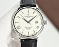 Analog wristwatch with black leather strap, white dial, baton hour markers, rose hands.