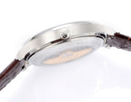 Vacheron Constantin wristwatch caseback with engraved emblem, brown leather strap