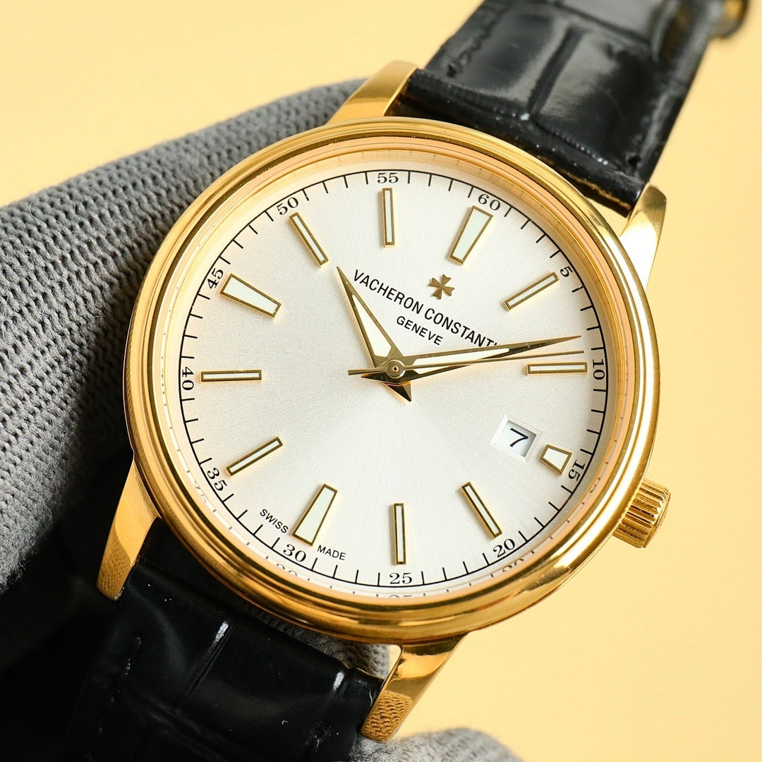 Gold wristwatch with white dial and black leather strap, date at 7 o'clock