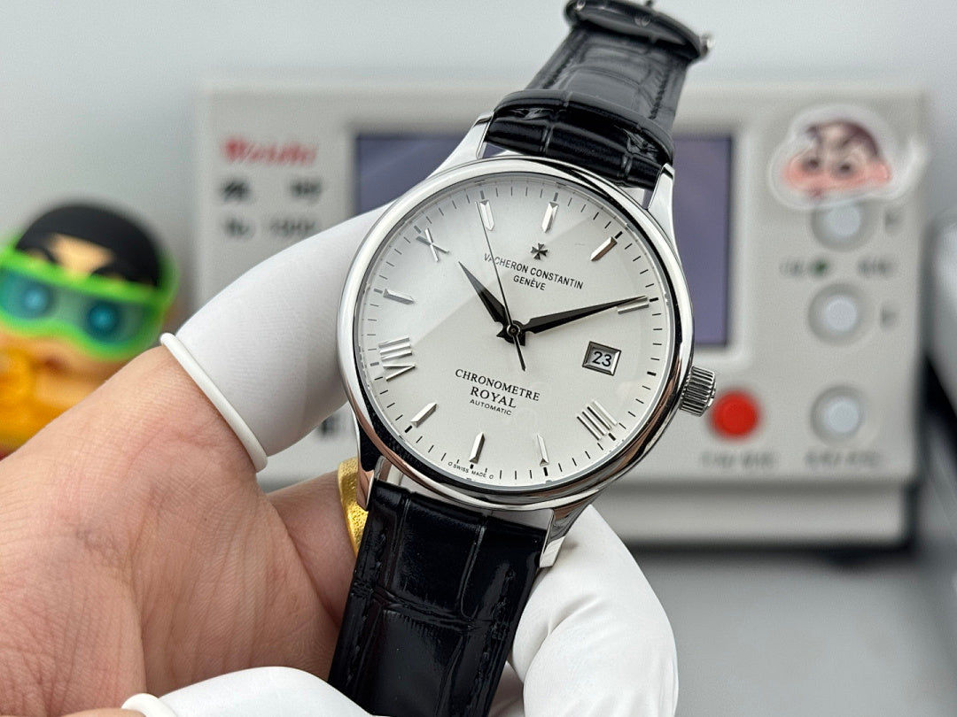 Chronometre Royal watch with white dial and black leather strap, held in gloved hands