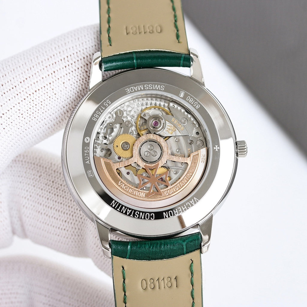 Skeleton-style watch case with green leather strap and gold-toned movement visible