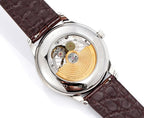 Vacheron Constantin wristwatch open caseback showing gold-toned movement, brown strap