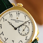 Vacheron Constantin watch close-up: white dial with Roman numerals and gold-tone bezel.