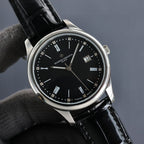 Vacheron Constantin wristwatch front view with black dial, silver case, black leather strap