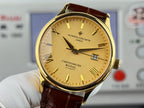 Gold wristwatch with yellow dial and brown leather strap, crown side visible
