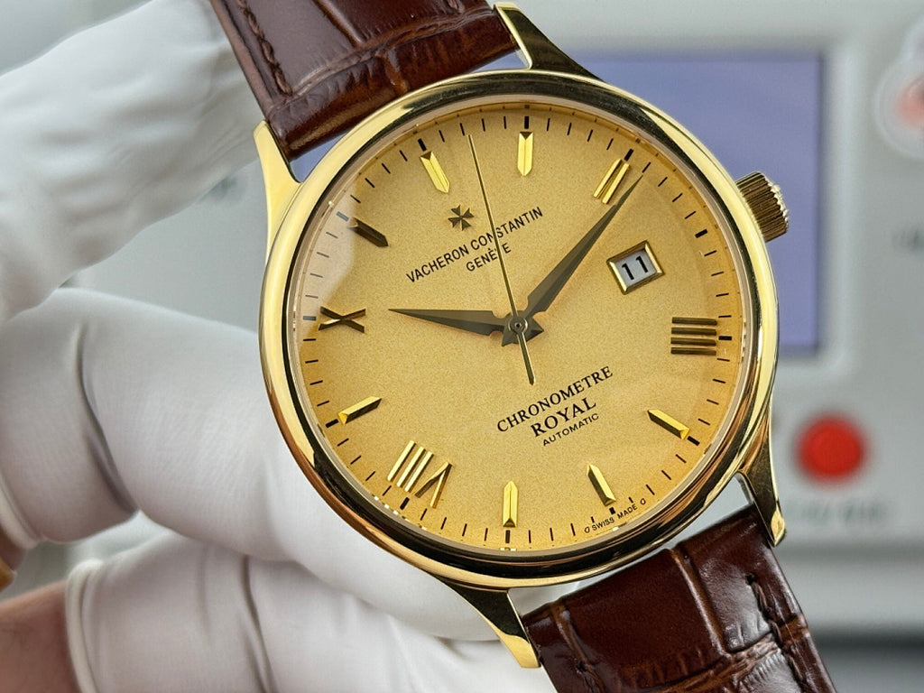 Gold wristwatch with yellow dial and brown leather strap, close-up front view