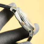 Vacheron Constantin wristwatch side view with polished silver case and black leather strap