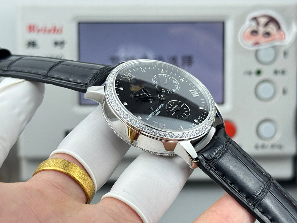Vacheron Constantin watch with black dial and silver bezel, angled view on black leather strap