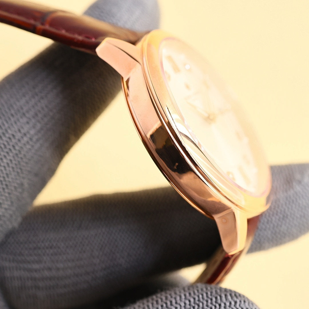 Wristwatch rose-gold case side with polished finish, on brown leather strap.