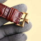 Wristwatch strap with brown leather and rose-gold buckle clasp.