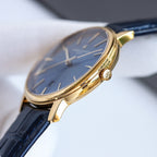 Vacheron Constantin watch side profile with blue dial, gold case, navy leather strap