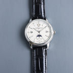Automatic wristwatch, silver case and black leather strap, cream dial with subdial