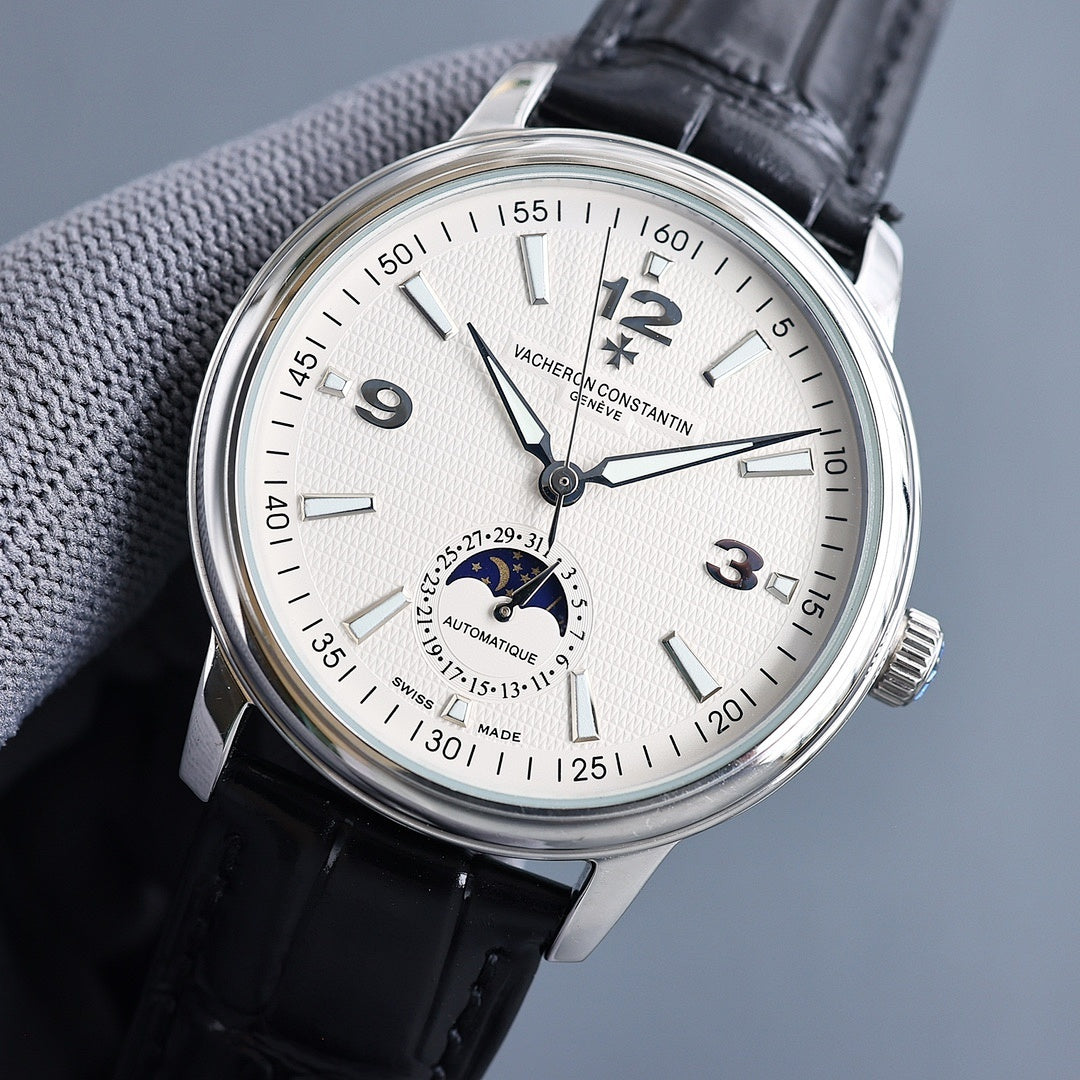 Automatic wristwatch, silver bezel, cream dial with large numerals, black leather strap