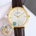 Gold dress watch with white dial, brown leather strap, gold hands, and date window at 9