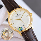 Gold dress watch with white dial, brown leather strap, gold hands, and date window at 9