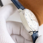 Wristwatch clasp and case side with brown leather strap, visible crown and smooth case edges