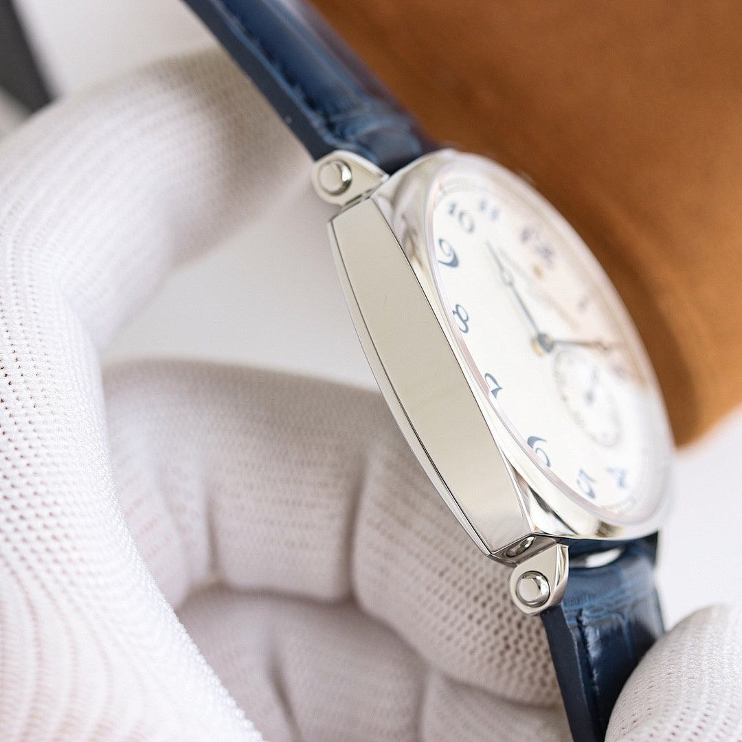 Wristwatch clasp and case side with brown leather strap, visible crown and smooth case edges