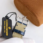 Wristwatch with blue leather strap, metal buckle clasp, and hanging brand tag