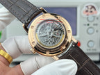 Luxury wristwatch case back with mechanical movement window, gold tone and black leather strap.