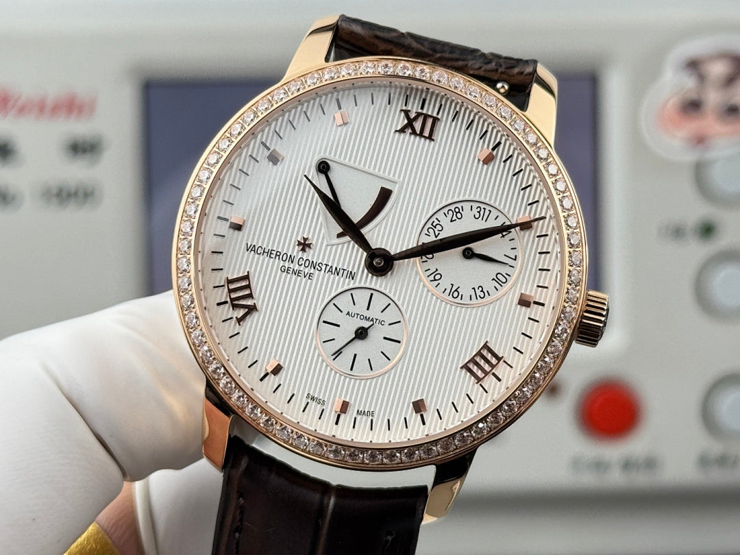 Luxury wristwatch with white dial, rose-gold bezel and hands, black leather strap, small subdials.