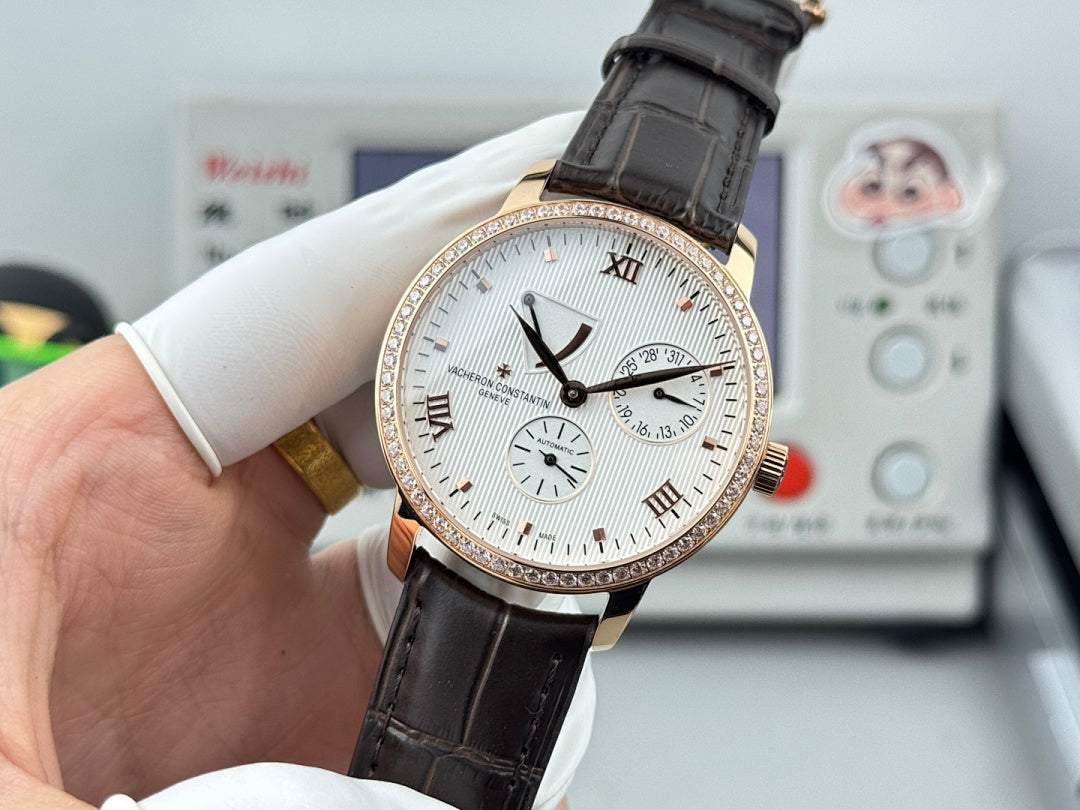 Luxury wristwatch side view with white dial, rose-gold case, black leather strap and bezel stones.