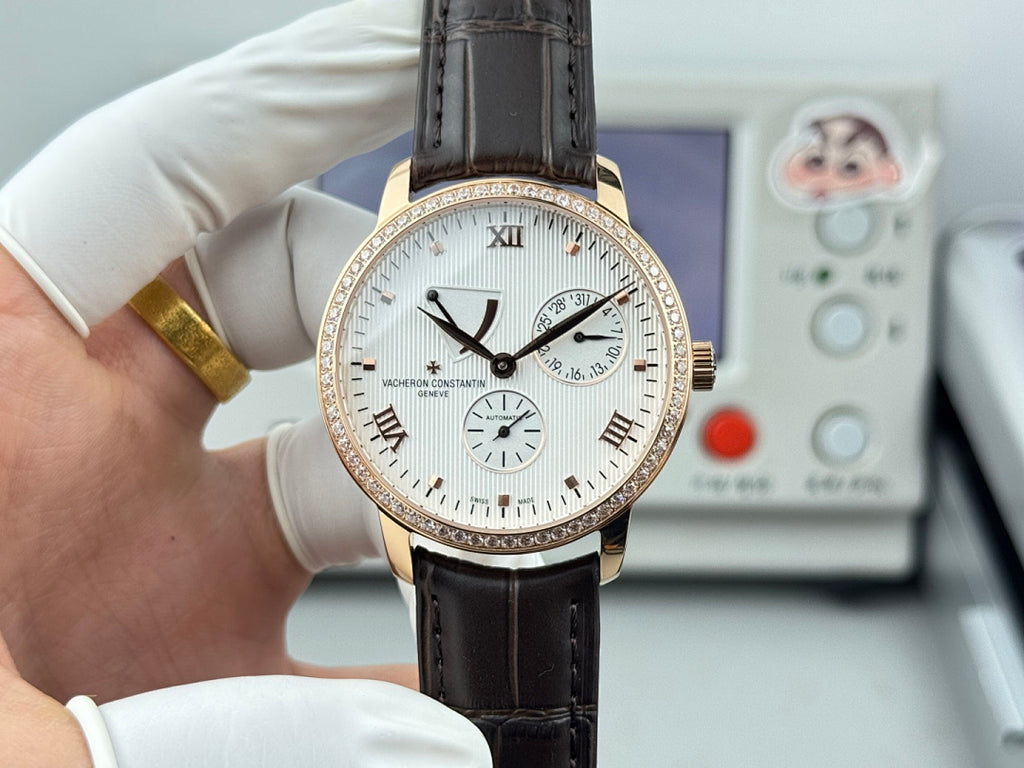 Luxury wristwatch with white dial, rose-gold bezel, black leather strap, Roman numerals.