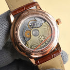 Open watch caseback showing gears and inscriptions, brown leather strap
