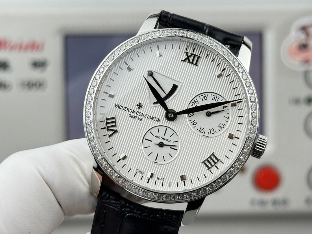 Vacheron Constantin wristwatch with textured white dial, black leather strap, silver bezel.