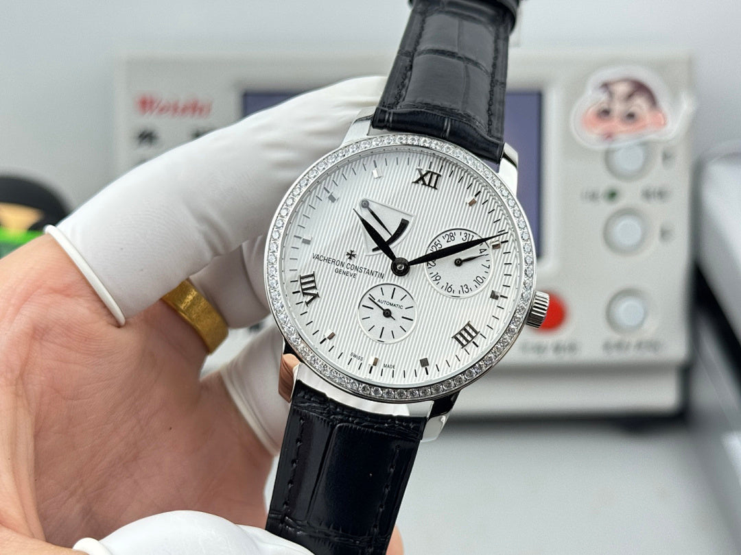 Vacheron Constantin wristwatch with white dial, black leather strap, visible black hour markers.