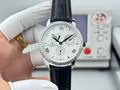 Vacheron Constantin wristwatch with silver case, black leather strap, white dial, three hands.