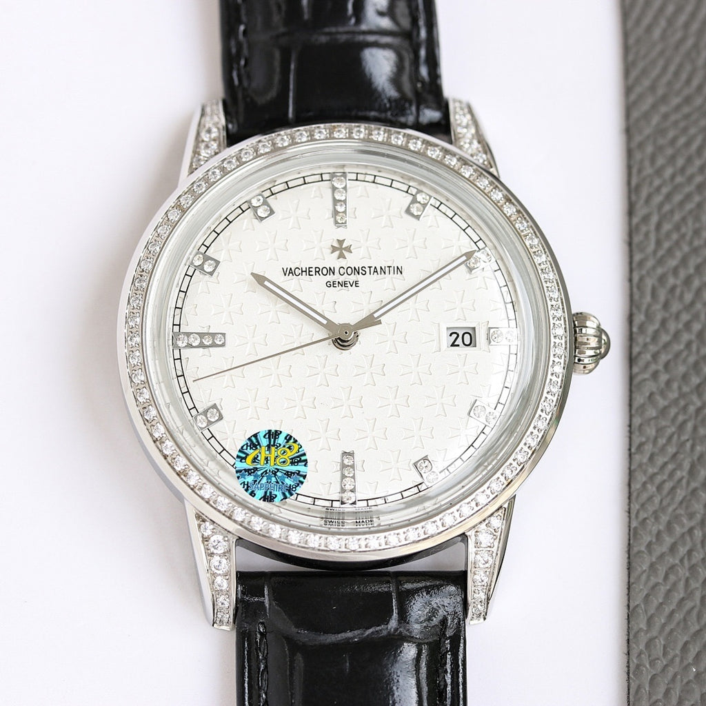 Silver wristwatch with white dial, diamond bezel, black leather strap and date window
