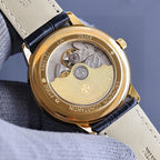 Vacheron Constantin watch caseback with gold rim and engraved medallion, on black strap