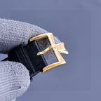 Vacheron Constantin watch with gold-tone case and black leather strap, side crown view
