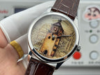Watch with brown leather strap and silver bezel, showing gold-tone city building dial.