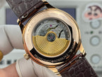 Wristwatch case back with gold textured disc and visible mechanical gears under glass