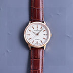 Vacheron Constantin watch, white dial with rose-gold case, brown leather strap, slim hour markers.