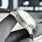 Vacheron Constantin watch with diamond-studded silver case and black leather strap.