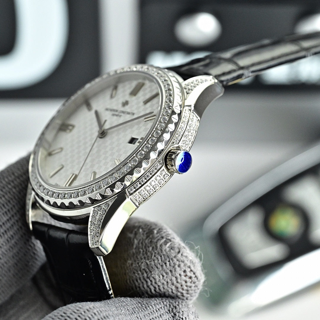 Vacheron Constantin watch with silver bezel, black leather strap, and blue crown detail.