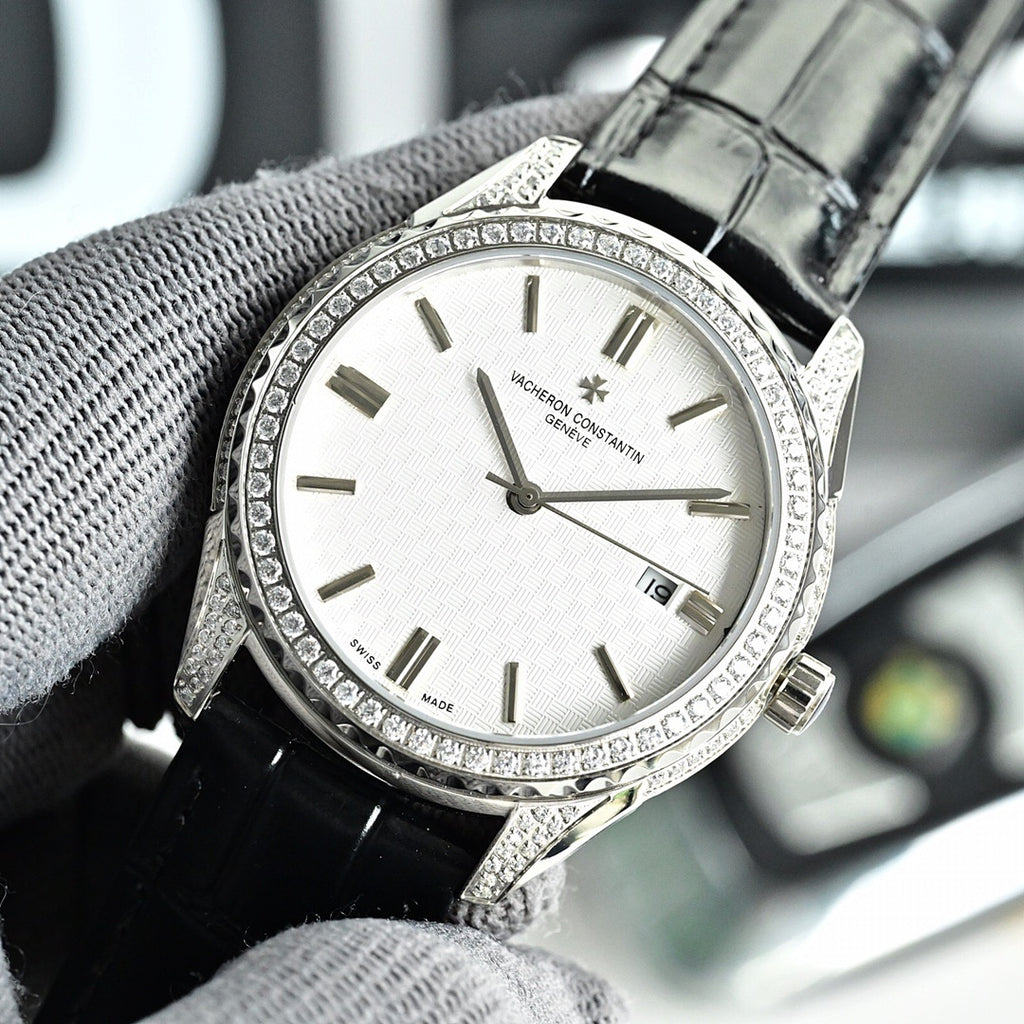 Vacheron Constantin watch with diamond bezel, white dial, and black leather strap.