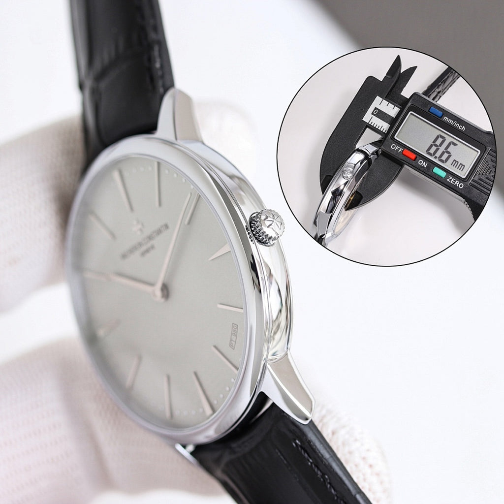Wristwatch with white dial and black leather strap, side profile with crown visible.